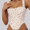 Adina witte katoenen corset-top met rozenprint en geschulpte rand