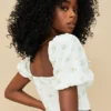 Arianna ivoorkleurige cropped top met bloemenprint en pofmouwen