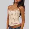 Cadie ivoorkleurige katoen-korset-top met vintage rozenprint
