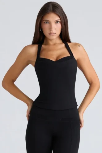 De Peekaboo zwarte halternek-korset-top