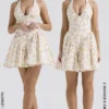 Valentia ivoorkleurige mini-halterjurk met weideprint