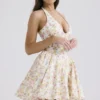 Valentia ivoorkleurige mini-halterjurk met weideprint